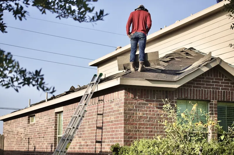 Professional roofer working on a residential roof in Dunn Loring